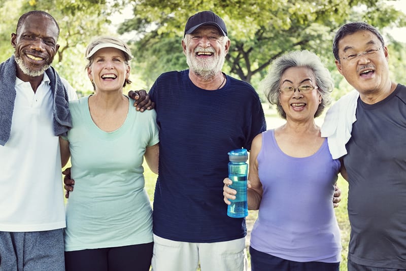 Group of senior adults smiling and enjoying time together in Denison, Texas.