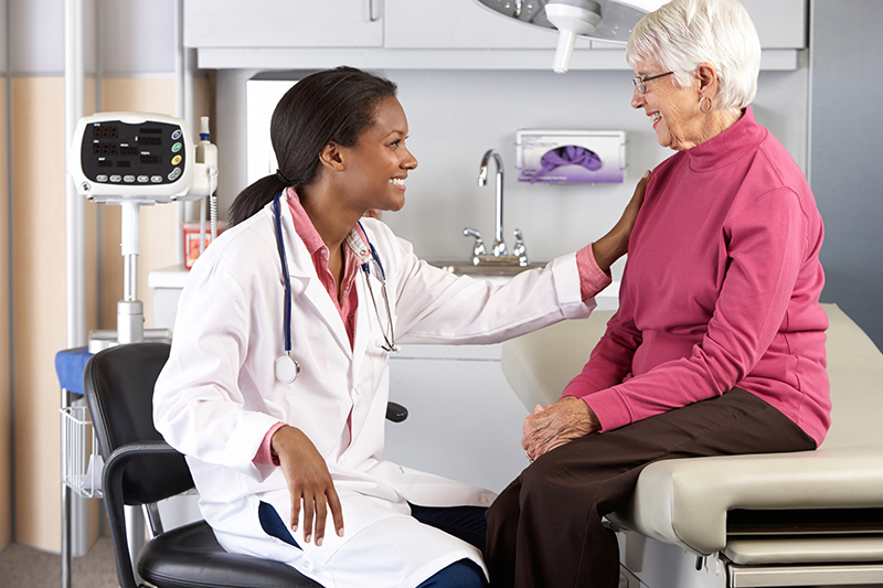 Doctors talking with elderly women at Homestead of Denison in Denison, Texas.